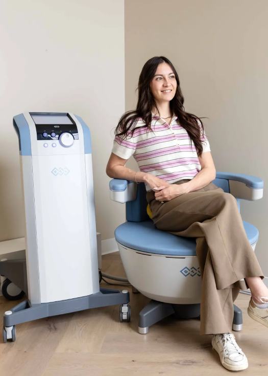 A patient seated for a pelvic floor strengthening session