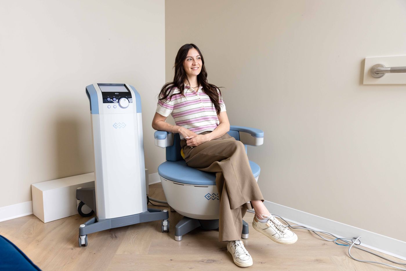 A patient seated on the EMSELLA® chair at Westside, Calgary SW