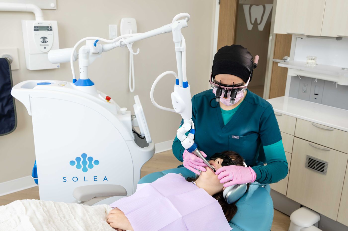 Dr. Zubaida Hussain performing a Solea laser procedure on a young patient at Westside, Calgary SW
